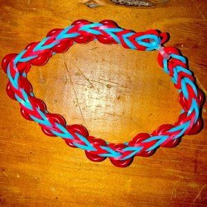 Made with red beads.                          Blue and red rubber bands crossed